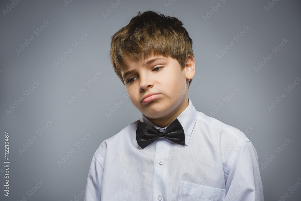 Closeup sad boy with worried stressed face expression Closeup sad boy with worried stressed face expression