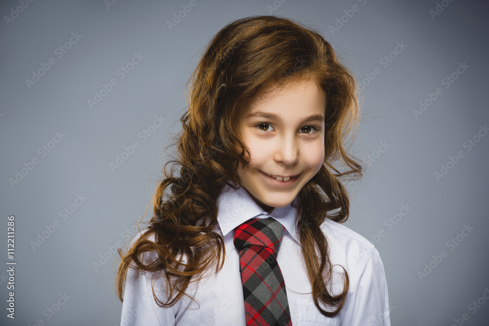Happy girl. Closeup Portrait of handsome teen in casual shirt smiling while standing against grey background Happy girl. Closeup Portrait of handsome teen in casual shirt smiling while standing against grey background