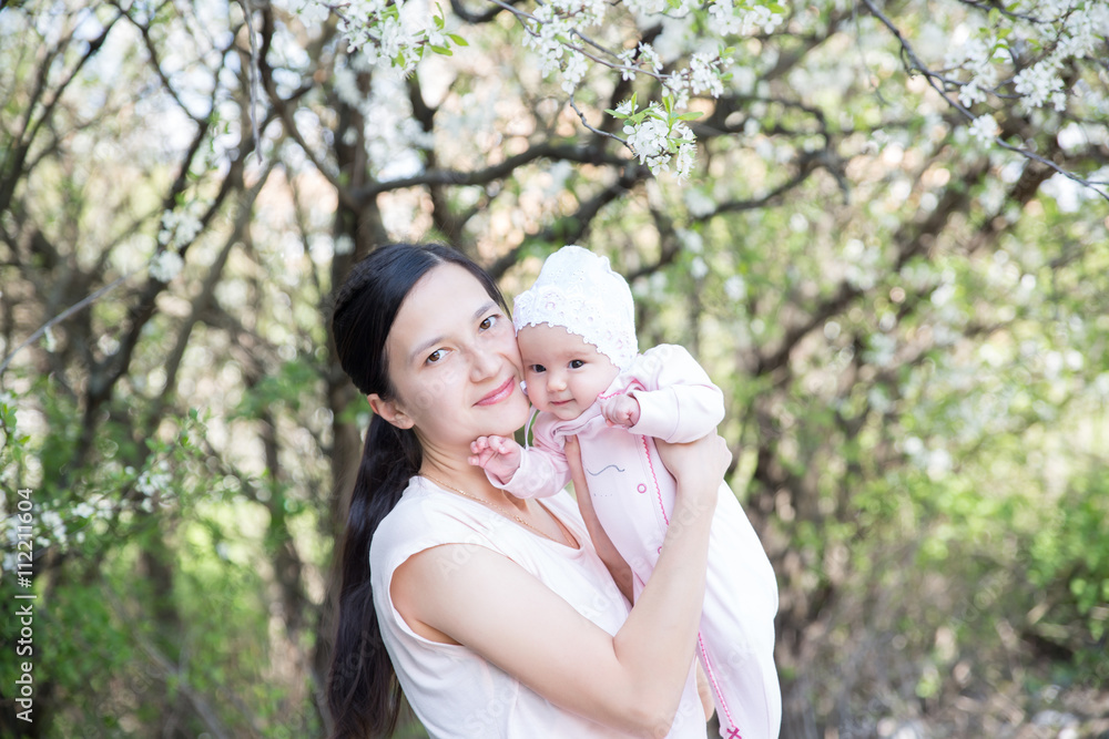 Mother and daughter under tree. Soft focus