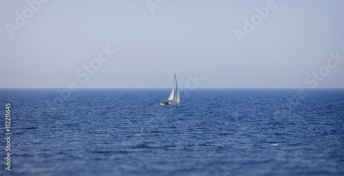 Lonely yacht sailing in sea