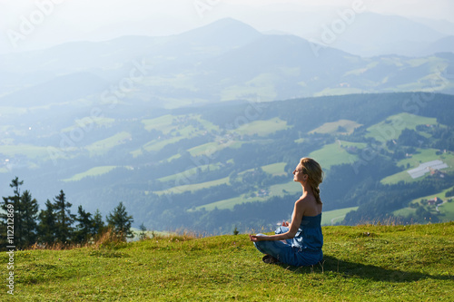 Young woman practice yoga on mountain peak