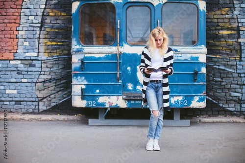 girl with a book at graffiti and subway train