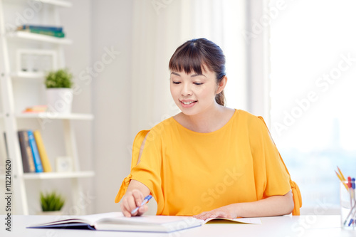 happy asian young woman student learning at home