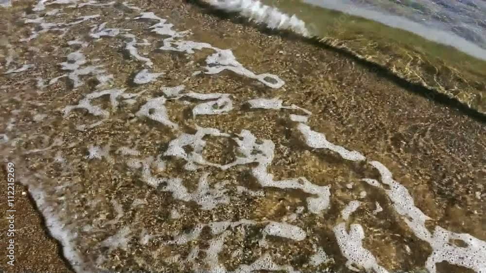 Sea Waves over Sand Beach .