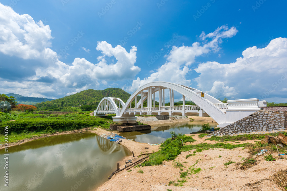 Fototapeta premium Old white railway bridge constructed against blue sky at Lamphun