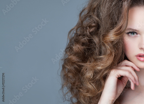 vogue style portrait of beautiful delicate woman with curly long photo