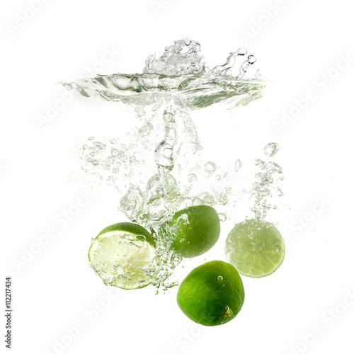 Limes splash on water, isolated on white background. Fresh drinks advertisment
