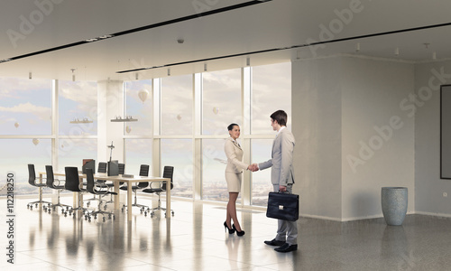 Two business partners shaking hands