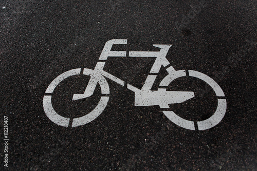 Bicycle road sign on road of white colour. Bicycle road sign on asphalt. Leisure activities.