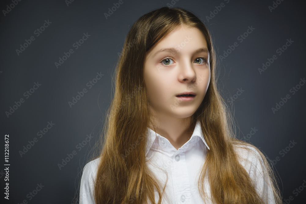 Closeup Portrait of happy girl going surprise isolated on gray background Closeup Portrait of happy girl going surprise isolated on gray background