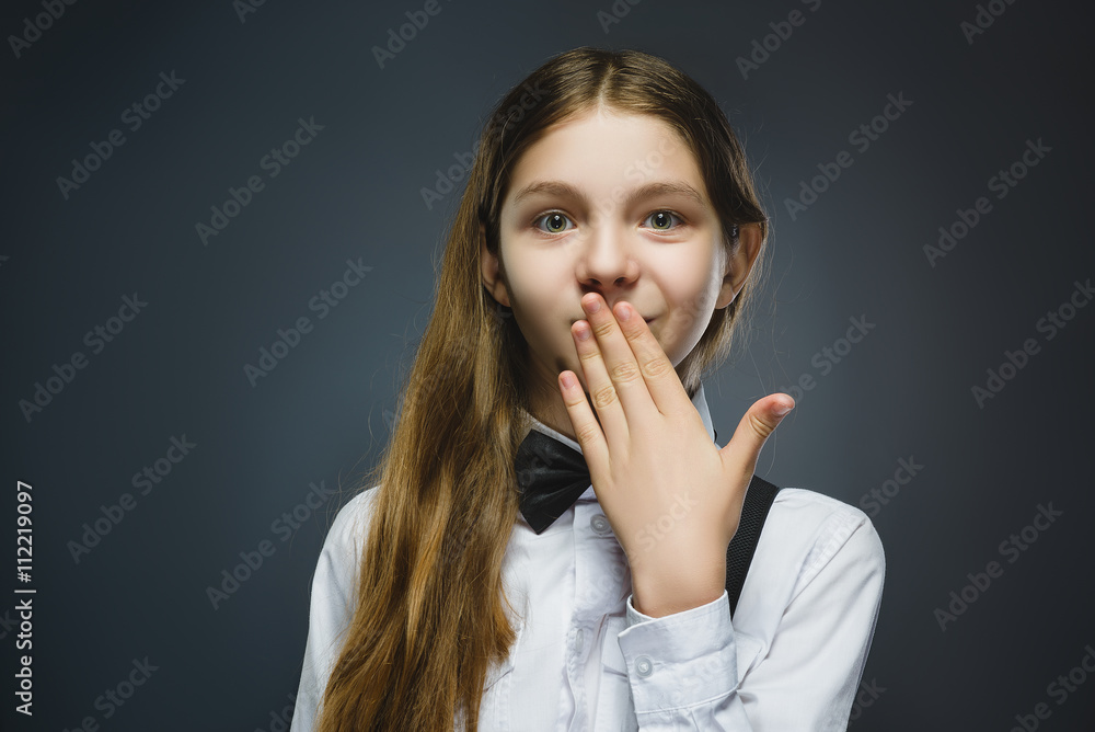 Closeup Portrait of wondering girl going surprise on gray background Closeup Portrait of wondering girl going surprise on gray background
