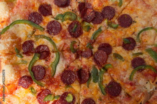 Delicious chorizo and pepper pizza, on the chopping board
