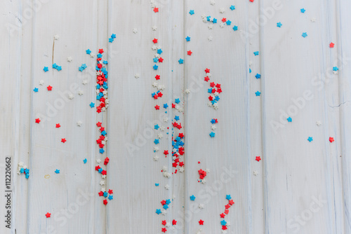 background concept, Colored sprinkles stars on wooden boards