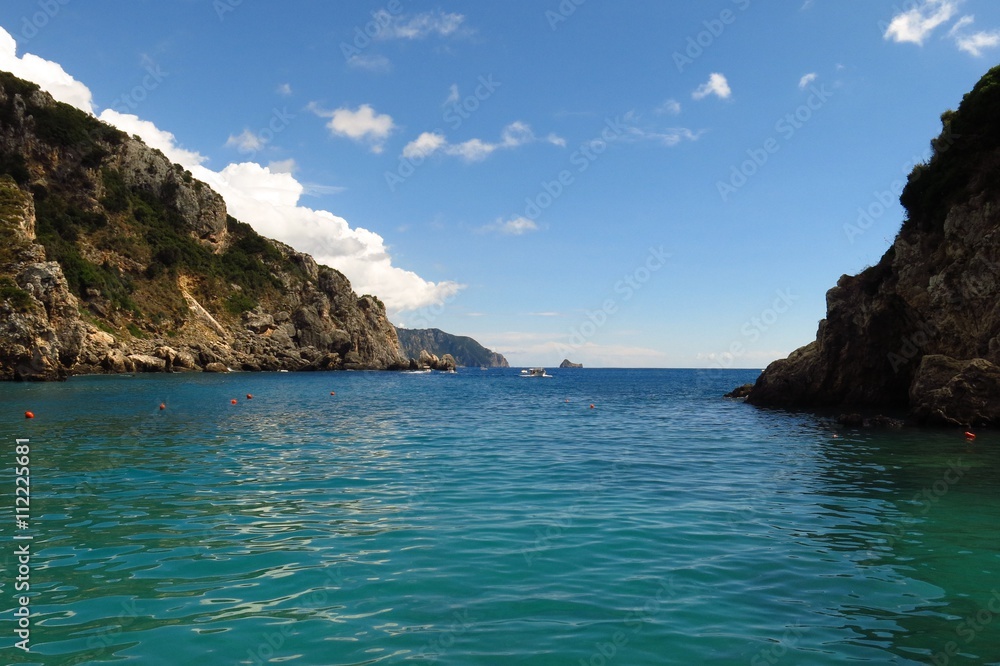 peaceful cove turquoise water beneath blue sky with copy space