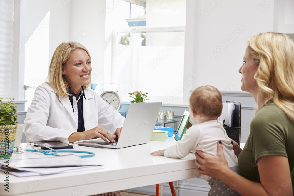Fototapeta premium Mother And Baby Meeting With Female Doctor In Office