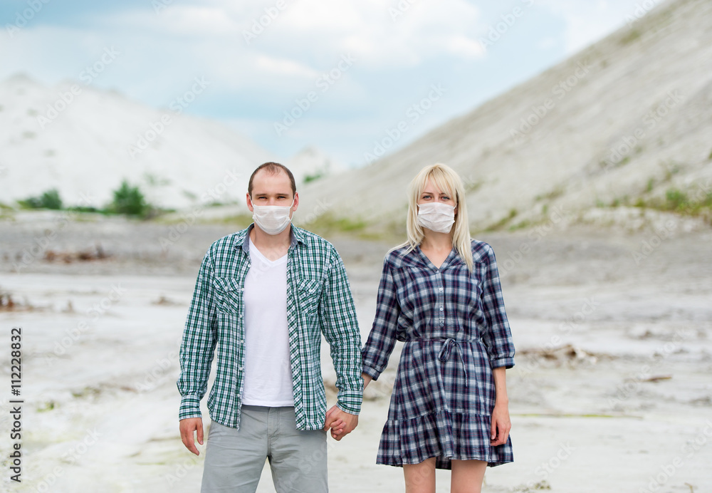 The man and the woman in respirators. Protection against viruses.