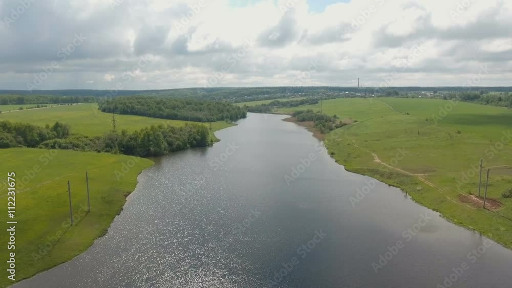Aerial View. Flying over the lake and green fields. Aerial View. Flying over the lake and green fields.
