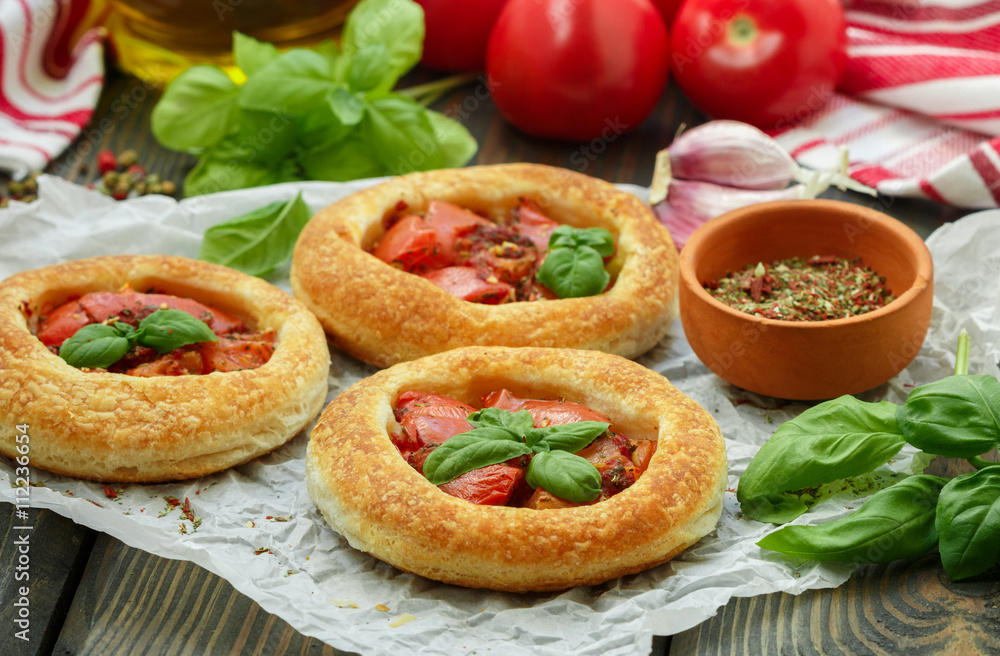 Homemade pie of puff pastry with tomatoes, Basil and spices Homemade pie of puff pastry with tomatoes, Basil and spices
