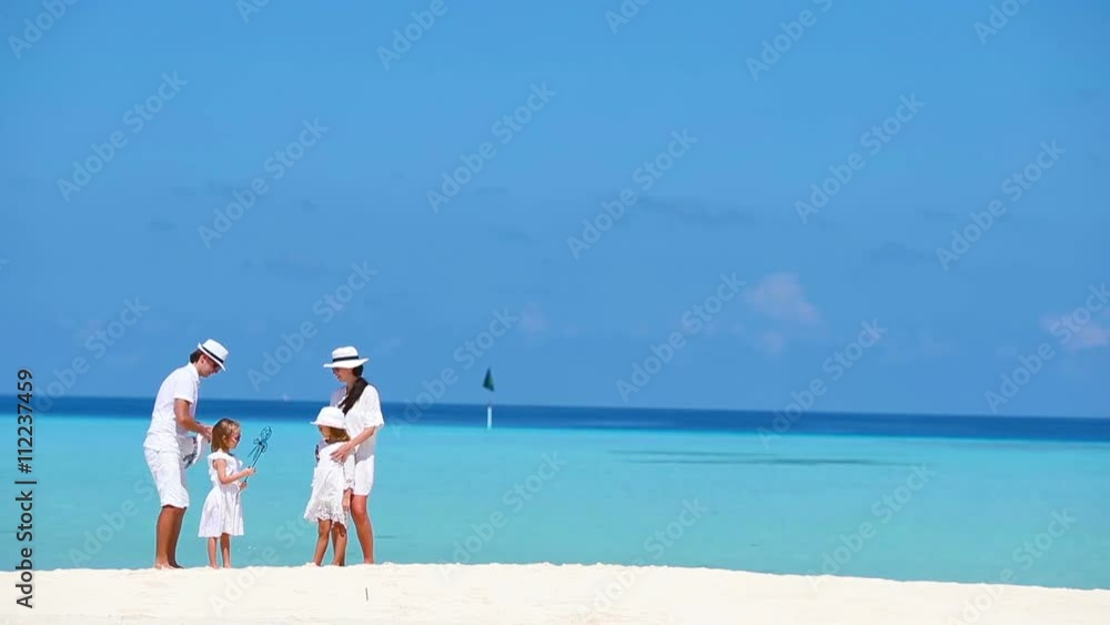 Happy beautiful family on white beach during summer vacation Happy beautiful family on white beach during summer vacation