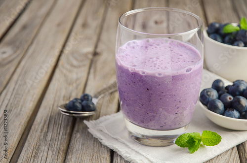 Blueberry and banana smoothie with oatmeal on the rustic wooden table, copy space, selective focus