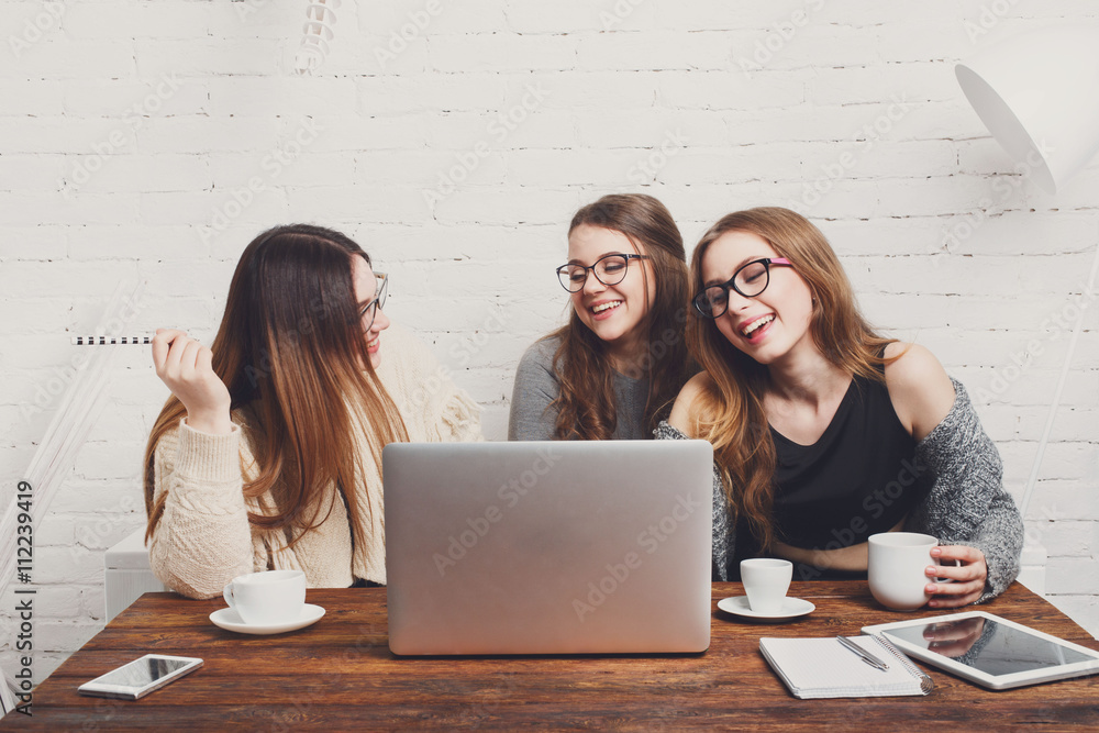 Portrait of three laughing girlfriends with laptop. Portrait of three laughing girlfriends with laptop.