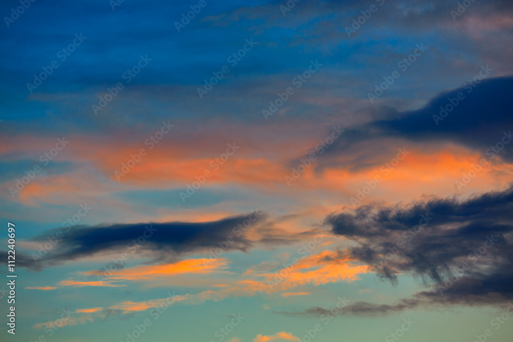 Obraz premium Sunset orange clouds in a blue sky