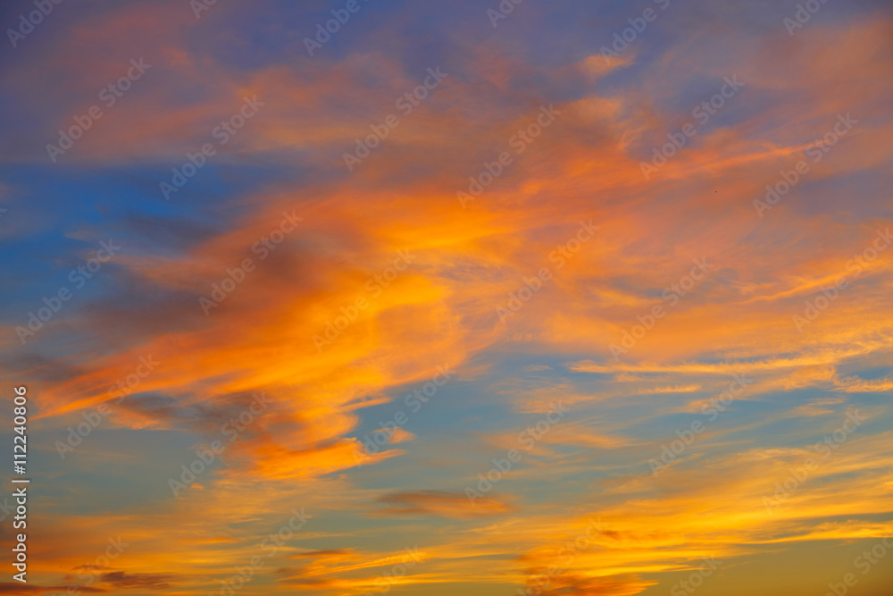 Sunset orange clouds in a blue sky