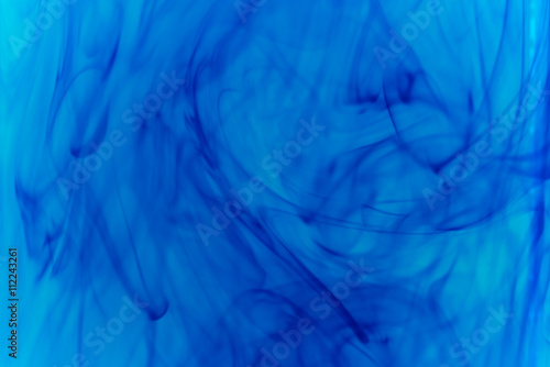 Abstract pattern falling into the water drop of blue ink - cyan ink dissolved in water 