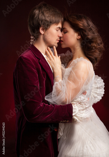 pretty young lady in old time and man in red medieval dress 