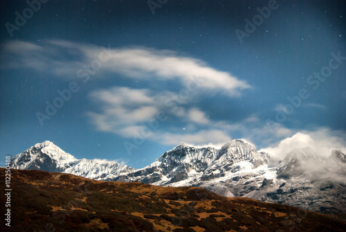 Mountains under night sky with stars