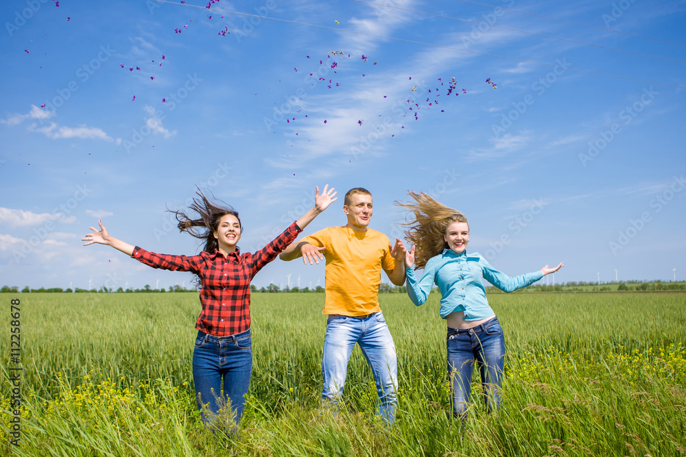 Young happy Friends running on green wheat field Young happy Friends running on green wheat field