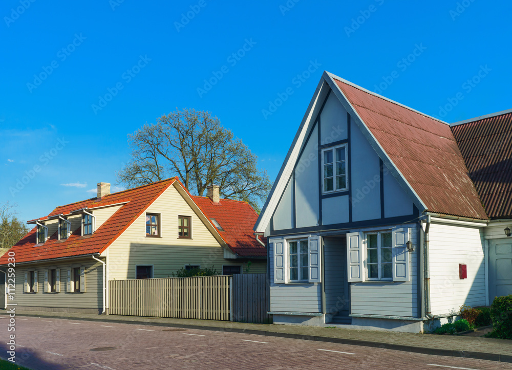 Houses with wooden fence in Ventspils of Latvia