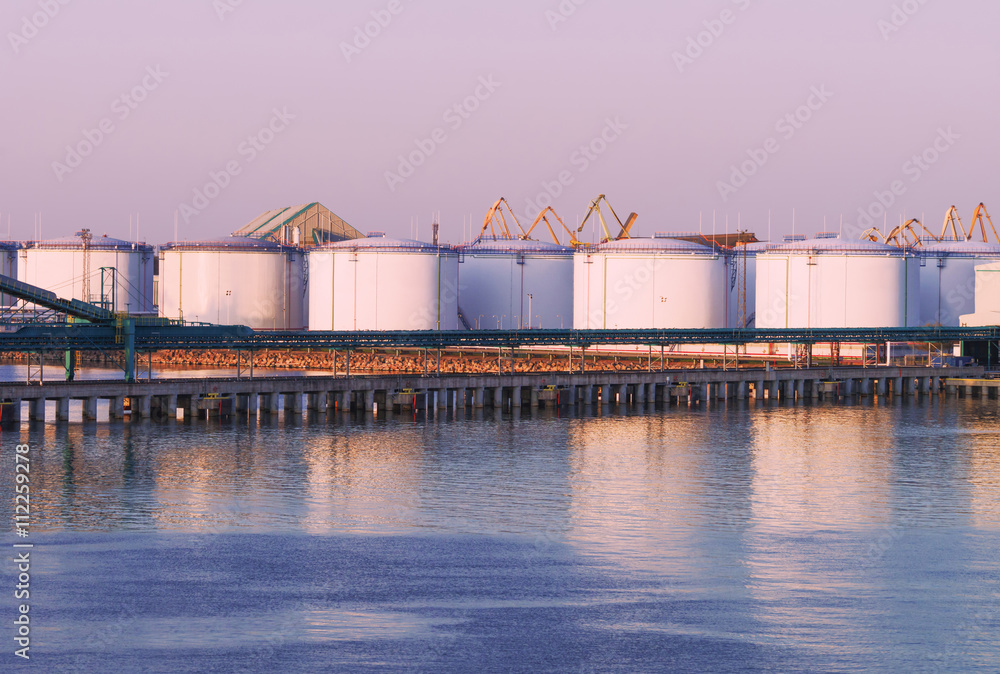 Oil bunkers at the Marina in Ventspils at sunset Oil bunkers at the Marina in Ventspils at sunset