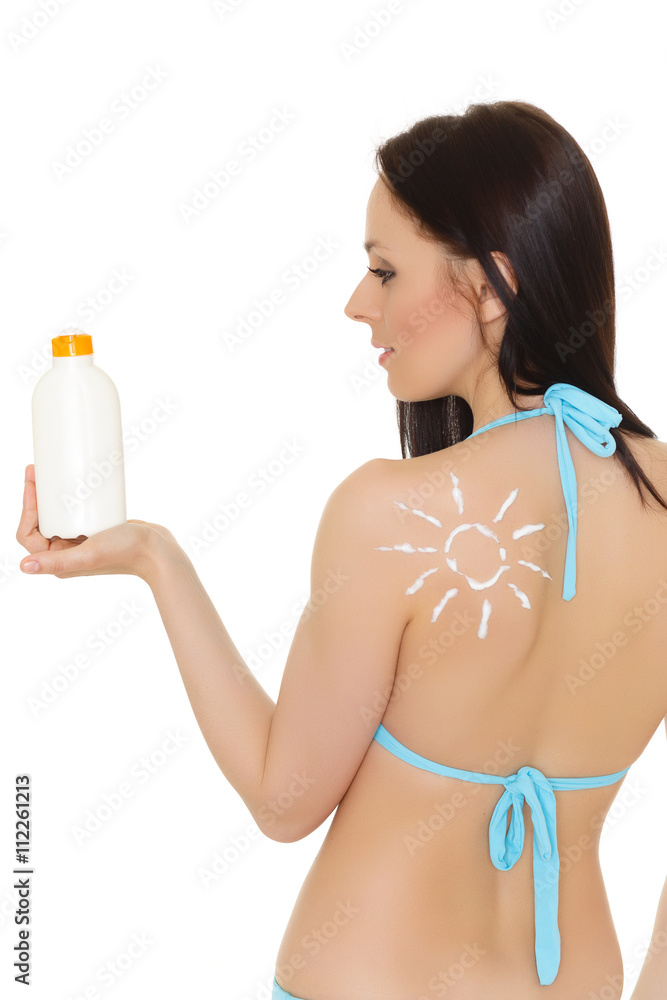Young woman in bikini with sunscreen. Young woman in bikini with sunscreen.