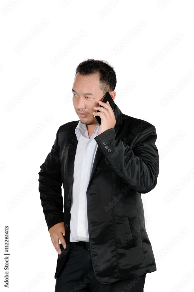 Asian business man in a suit talking on the mobile phone isolated on white background. Asian business man in a suit talking on the mobile phone isolated on white background.