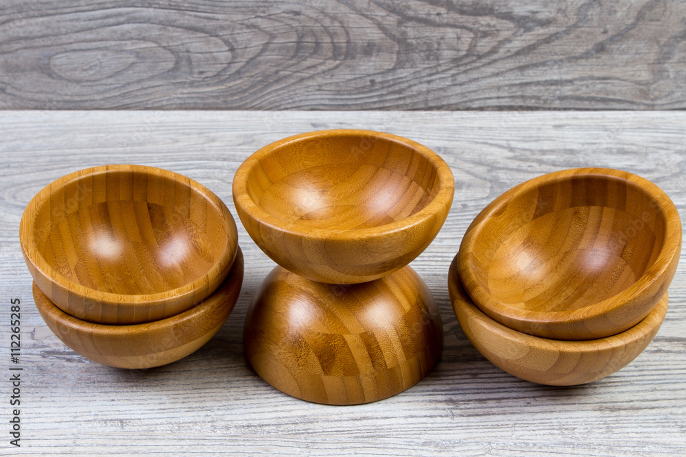 Top view of wooden bowl on wooden background