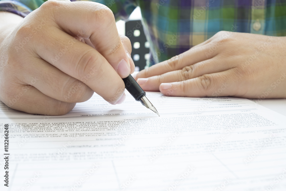 Asian Business woman signing a contract document making a deal. Asian Business woman signing a contract document making a deal.