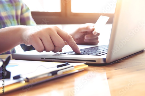 Woman using laptop and mobile phone to online shopping