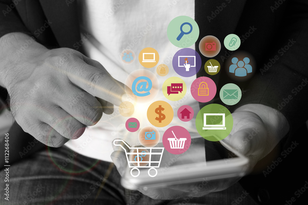 Young man are using shopping cart with application software icon Young man are using shopping cart with application software icon