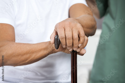 Senior Man Holding Cane In Rehab Center © Tyler Olson