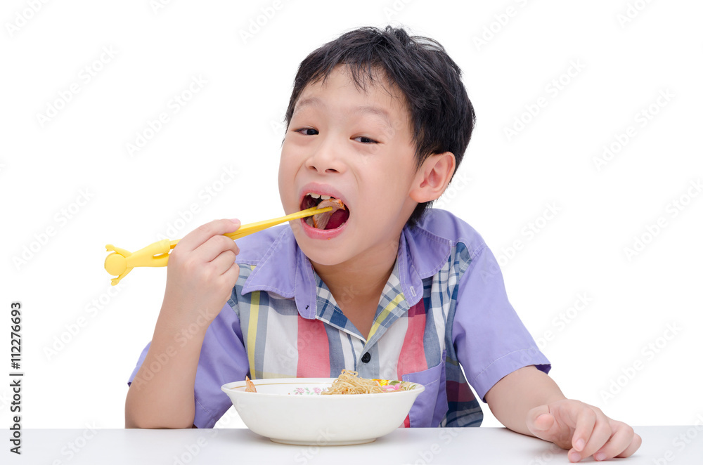 Young asian boy eating noodle by chob stick Young asian boy eating noodle by chob stick
