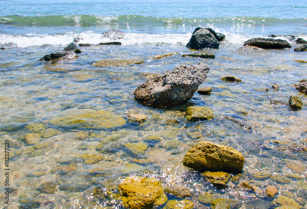 clear sea water through which one can see the stones