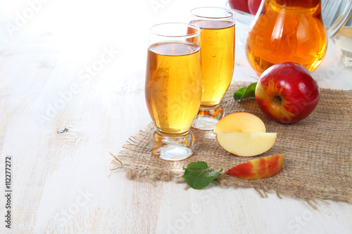 Apple juice and fresh red apples