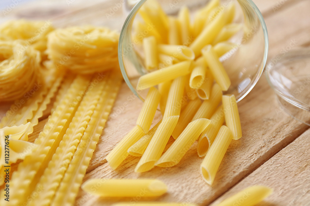 Rigate pasta on wooden table background Rigate pasta on wooden table background