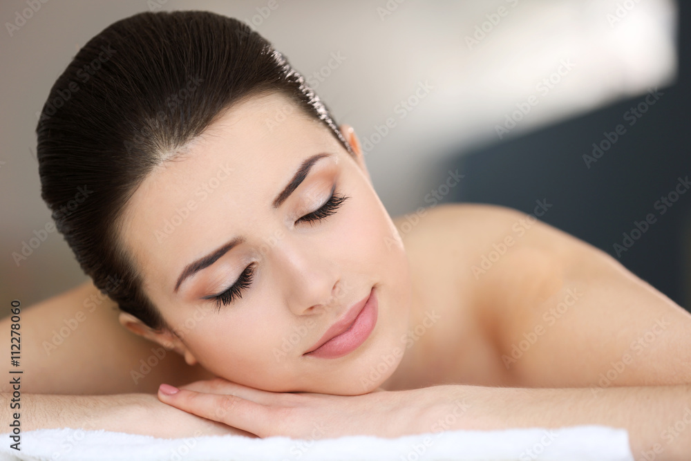 Young woman relaxing in spa center