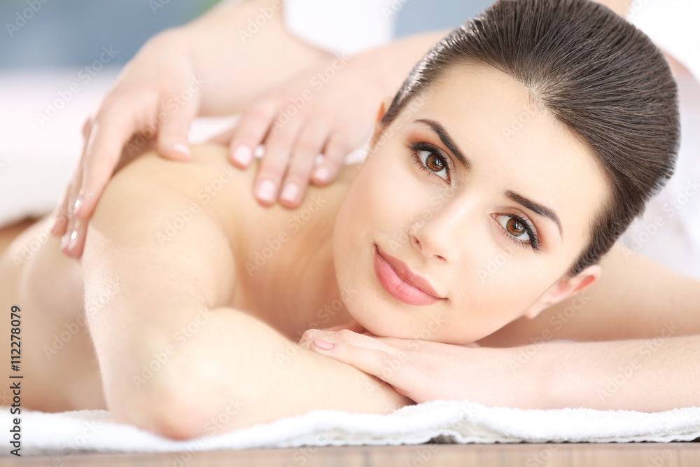 Young woman having massage in spa salon