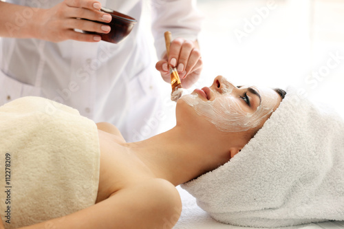 Young woman having mask pro...