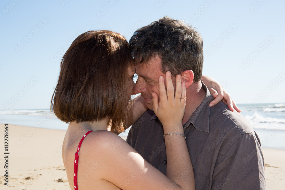 Portrait of young man and woman kissing on a beach. Portrait of young man and woman kissing on a beach.