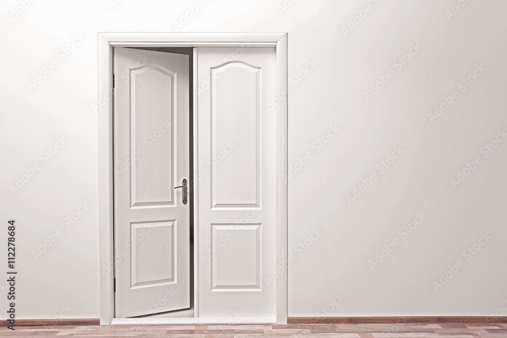 White wall and open door indoors White wall and open door indoors