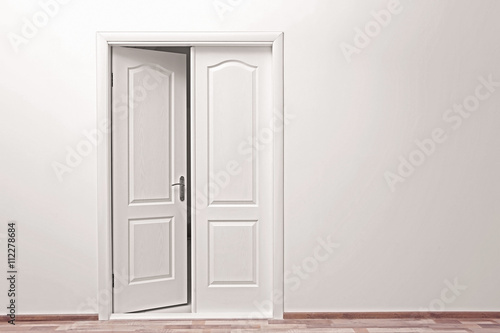 White wall and open door indoors